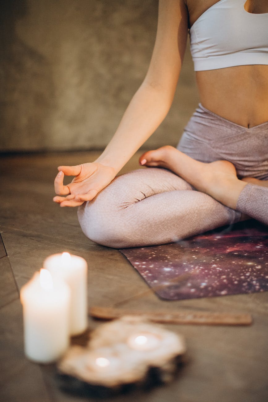 woman sitting in meditation before a somatic yoga session